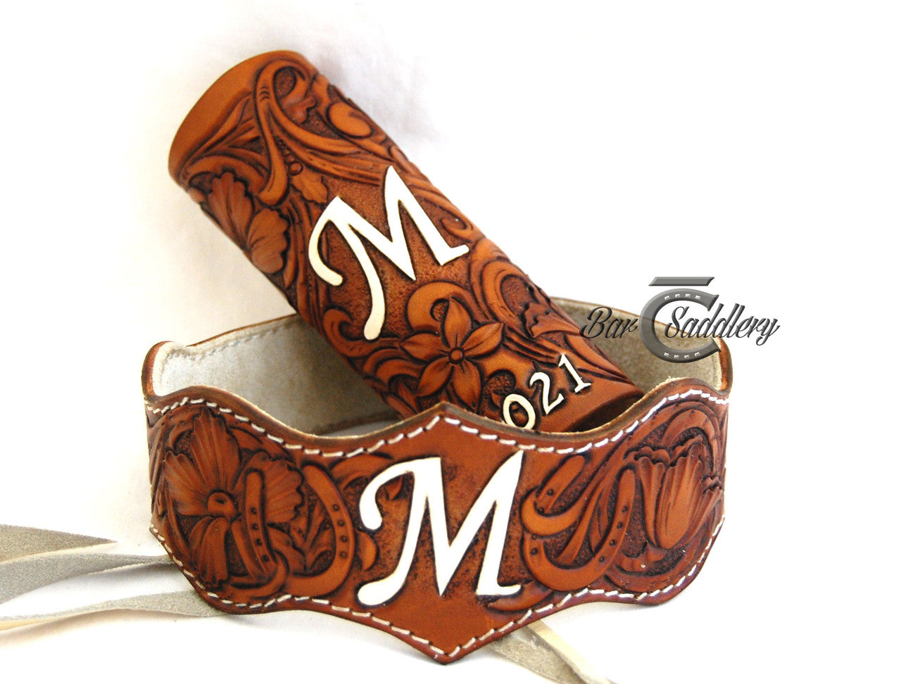 Custom hand tooled leather wedding garter belt pictured with custom bouquet wrap